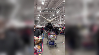 Man uses a shopping cart for gymnastics!