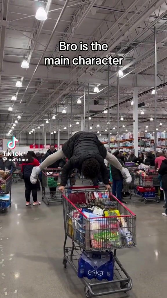 Man uses a shopping cart for gymnastics!