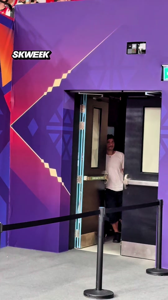 Panathinaikos owner Dimitris Giannakopoulos leaves the court and watches from the corridor.