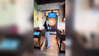 Just a girl playing darts