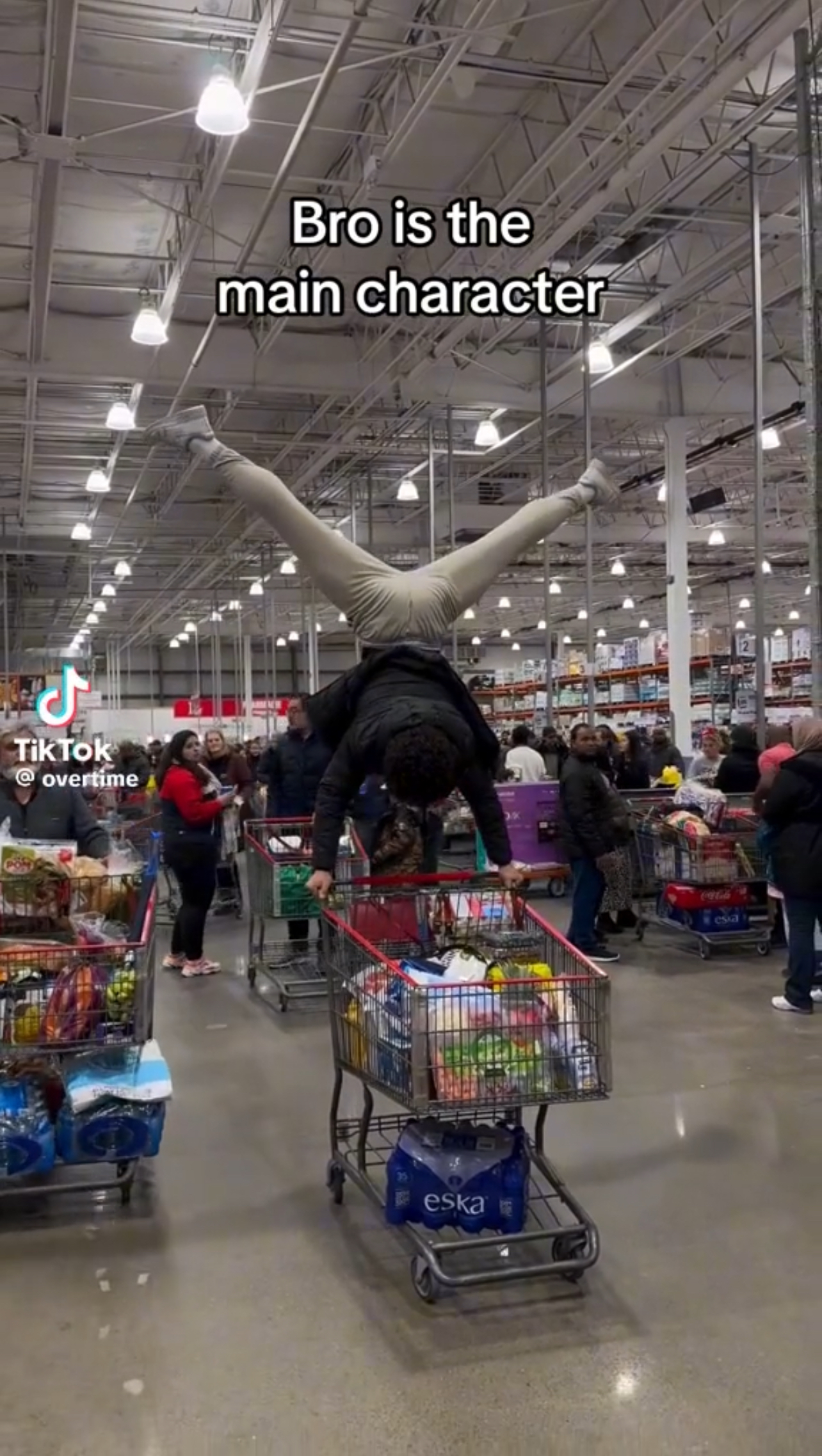 Man uses a shopping cart for gymnastics!