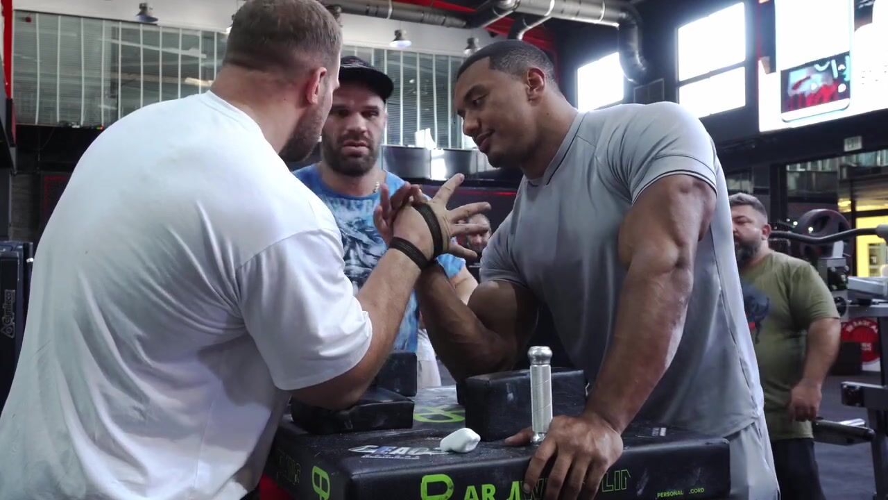Larry Wheels at an arm wrestling table during his crossover into another strength sport