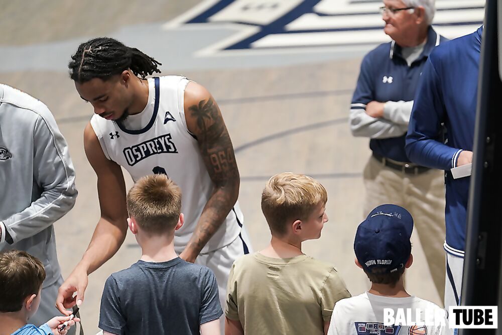 Player signing for young fans after a game